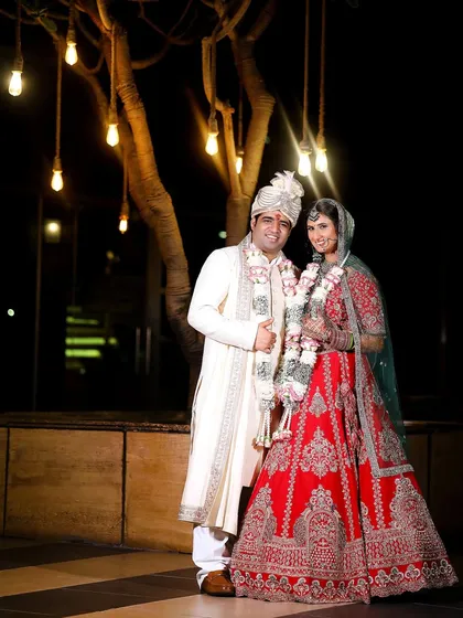 A romantic portrait of the couple under beautiful hanging lights. I always look for unique lighting to make your wedding photos magical.