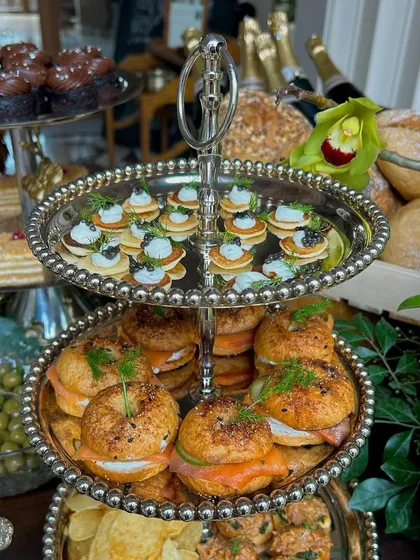 A close-up of the smoked salmon bagels and caviar blinis, showcasing the fresh dill and quality ingredients.
