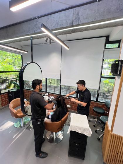 Our stylists working together on a client, showcasing our collaborative and hands-on approach.