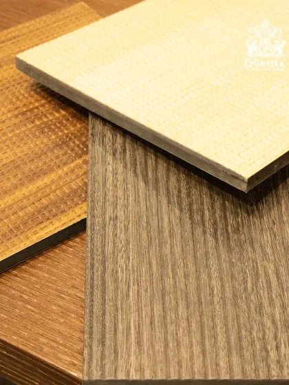 A simple, elegant shot of three different veneer samples. You can see a light woven texture, a classic wood grain, and a darker, linear pattern.