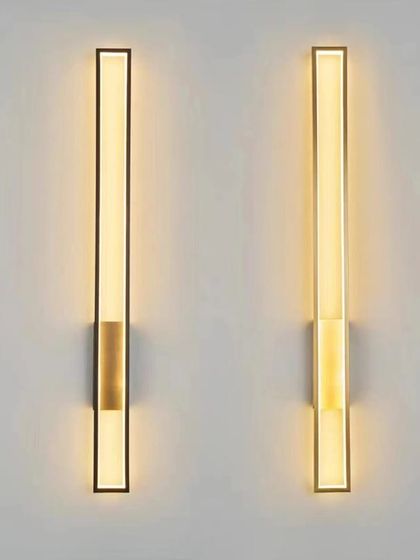 A minimalist linear wall sconce in black and brass finishes. The clean lines make it perfect for contemporary and industrial-style interiors.