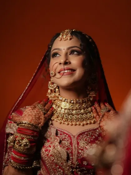 A portrait of bridal joy. Her makeup features a soft contour, a warm eyeshadow palette, and a smile that shows she's ready for her special day.
