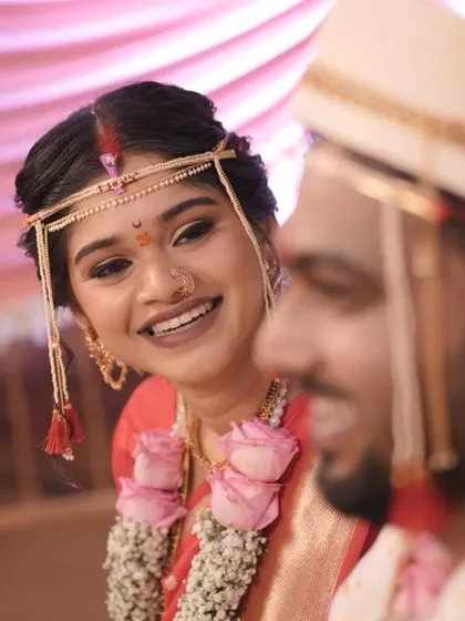 A candid moment of love and laughter between the couple. The bride's radiant smile is the best testament to a successful bridal look.