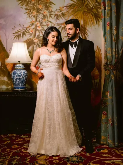 Classic elegance in a grand hotel. This portrait captures a timeless, formal romance, with the ornate decor adding to the sophisticated atmosphere.