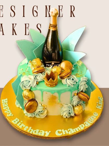 A celebratory "Champagne King" cake with a miniature champagne bottle, macarons, and a turquoise drip effect.