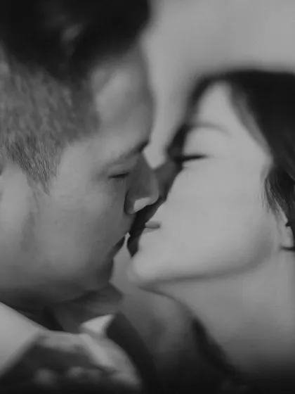 A soft, black and white close-up of a kiss, capturing a moment of pure intimacy. This timeless portrait from a destination shoot in Delhi focuses entirely on the couple's emotion.
