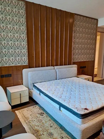 A final look at the installed bed and nightstand, showcasing the complete vision of a luxurious and comfortable master bedroom.