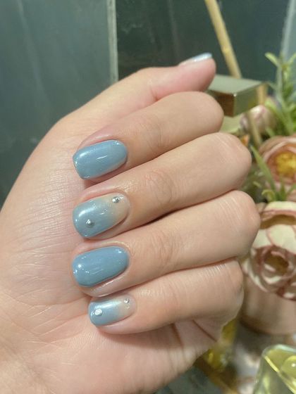 A magical combination of ombré and holochrome on short nails, with tiny rhinestone details.