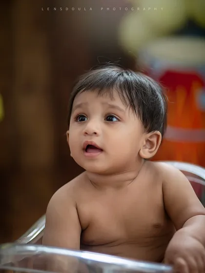 A simple, honest portrait. This close-up captures the beautiful details of this baby's face, from his curious eyes to his tiny features.