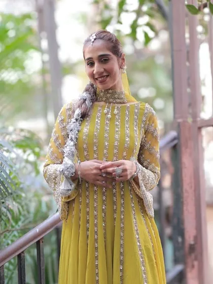 A classic portrait of the bride in her beautiful yellow attire. Her confident smile and relaxed pose make this a timeless image from her wedding celebrations.