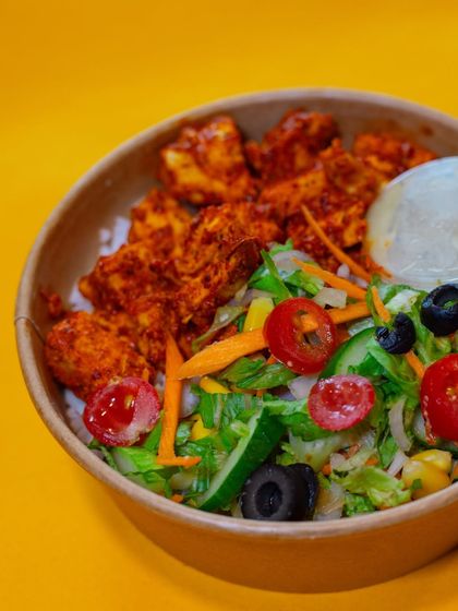 Another angle of our delicious Chicken Tikka Meal, highlighting the generous portion of chicken and the fresh, crisp salad that accompanies it.