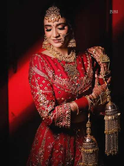 The bride looking down at her kaleere, a symbol of blessings from her family. This shot is full of tradition and emotion.