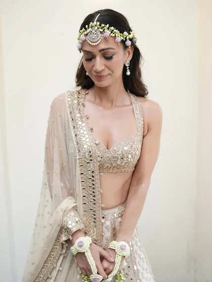 A bride's Mehendi ceremony calls for a look that is fresh, radiant, and lasts through the day. Here, I created a dewy, glowing base with soft, warm tones on the eyes and cheeks for Natasha Advani. This look is all about enhancing that natural bridal glow, ensuring she looks effortlessly beautiful.