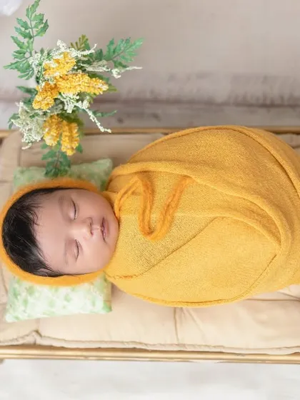 A top-down shot of the baby sleeping peacefully on the miniature bed.