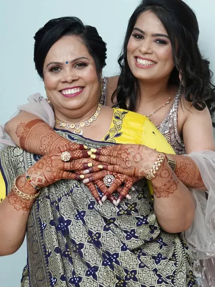 Nothing makes me happier than seeing the beautiful, dark stain of my organic henna on a happy client. Here, a mother and daughter share a joyful moment, showcasing the rich, long-lasting color my mehndi develops into.
