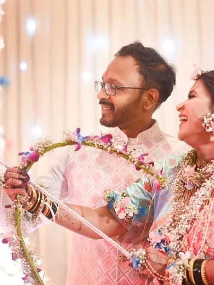 A couple enjoying a fun moment during their baby shower, adorned with our floral creations.
