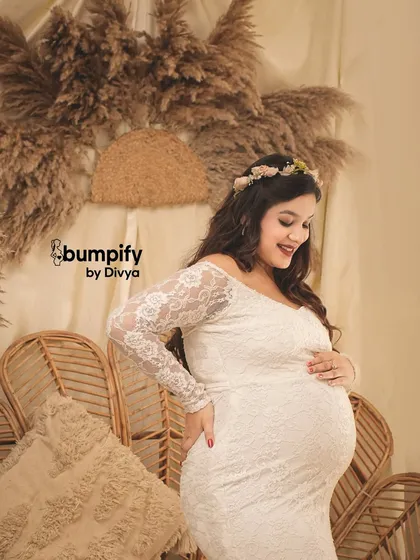 A sweet and happy close-up. The mom-to-be wears a flower crown that perfectly complements the boho theme of the shoot.