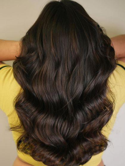 A student's work from our education program, mentored by our senior stylist. This showcases a beautiful bittersweet brunette color on long waves.