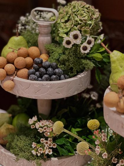 A memory from over a year ago, a tiered stand with fresh fruits and flowers. This image is a reminder of the madness and joy of getting every little detail just right.