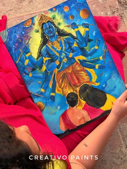 A creative shot looking down at the finished Vishnu painting, showing the rich texture and detail of the acrylic on canvas.