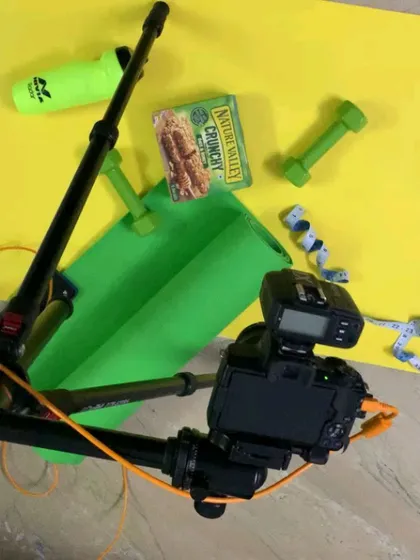 An overhead shot of our home studio setup for a fitness-themed flatlay, showing the camera rig and props.