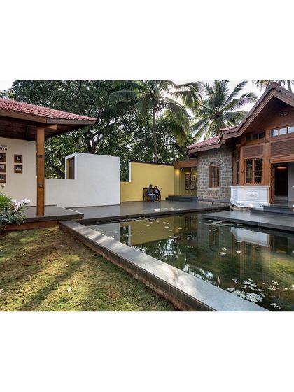 The restored colonial building sits in harmony with the new pavilions and water court. The project demonstrates how modern interventions can enhance and celebrate a heritage site.