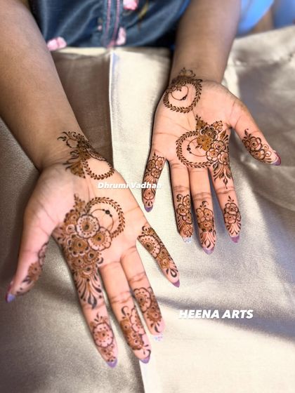 A whimsical and modern design with crescent moon shapes and delicate floral patterns scattered across the palm.