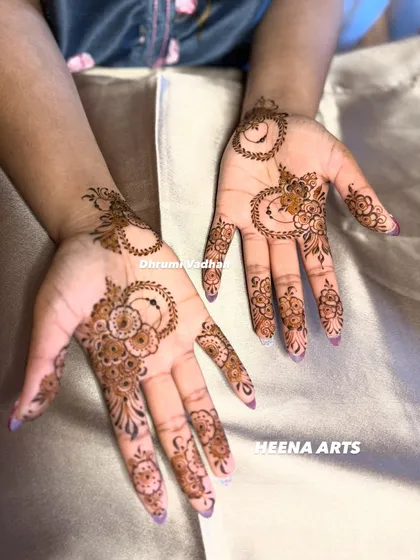 A whimsical and modern design with crescent moon shapes and delicate floral patterns scattered across the palm.
