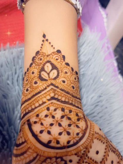 A close-up of a festive design, showing a heart-shaped motif at the wrist. It's the small details that make a design special.