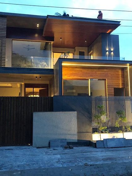 This is an in-progress shot of a home in Panchkula, showing the initial effect of the exterior lighting design. The linear LED profiles and downlights are strategically placed to define the structure's modern, cantilevered forms.