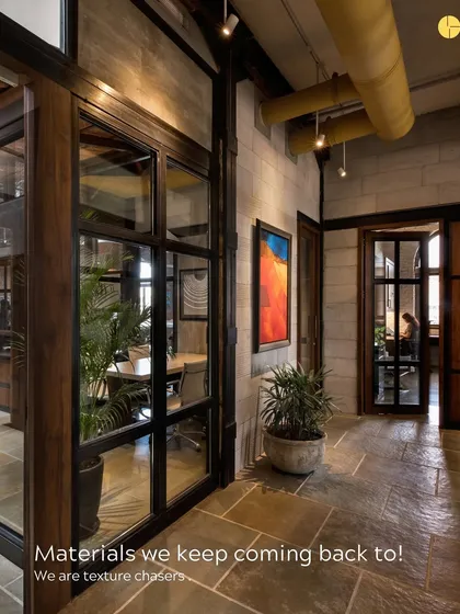 We are texture chasers. This image captures the interplay of materials we love: the cool, dark Shahabad stone floor, the warm wood of the door frames, and the rough texture of the concrete block wall.