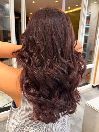 A beautiful brown global colour with rich tones and styled into soft curls.