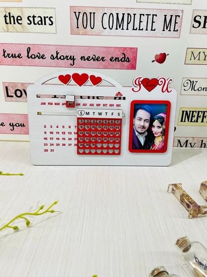 This is my "never-ending" table calendar with a love theme. Made of durable acrylic, it has a sliding mechanism to change the month and day, and includes a frame for a personal photo, so it can be used forever.