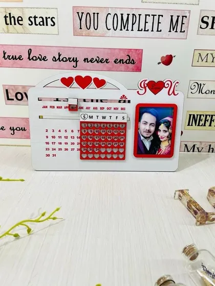 A perpetual calendar that never expires. This love-themed tabletop calendar includes a photo frame and can be used year after year.