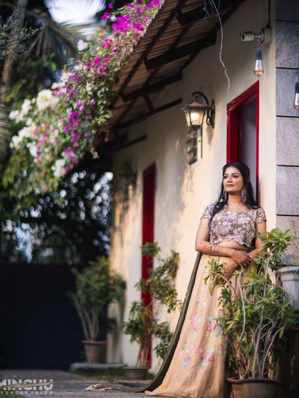 A solo portrait of the bride, Disha. Her soft makeup look with defined eyes and a natural lip color looks stunning against the rustic backdrop.