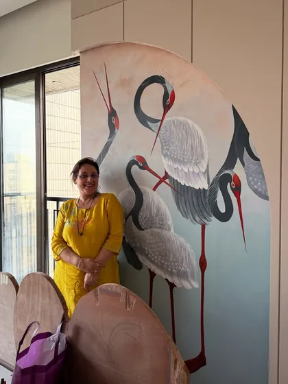 Another shot of my mother with her beautiful crane mural, a piece that truly elevates the bedroom space. Her artistic contributions add a layer of real family and soul to the homes I design.