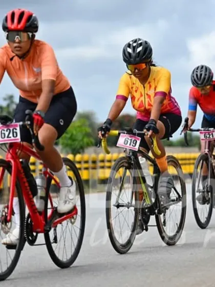 A group of women racers in a tight paceline, working together to maintain speed. This is a great example of teamwork and sportsmanship.