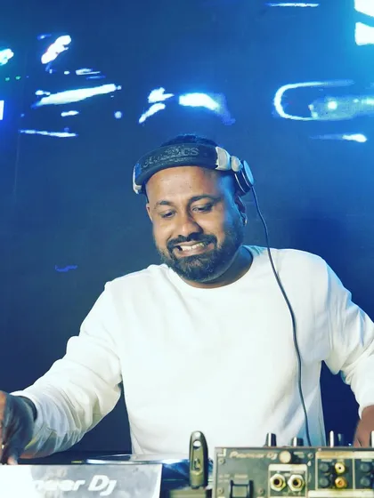 A smiling shot of me behind the decks. I truly love what I do, and that passion comes through in every performance.