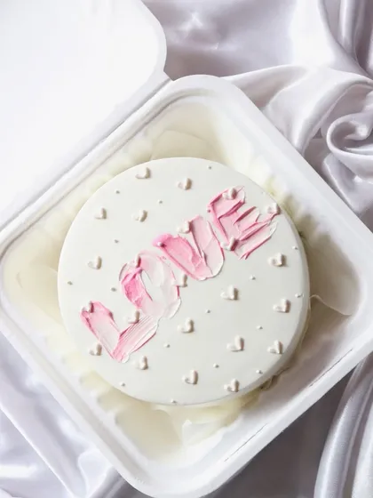 A minimalist bento cake with 'LOVE' written in a pretty pink textured frosting. Simple, aesthetic, and so sweet.