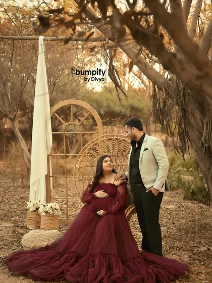 The dad-to-be stands beside his partner, sharing a loving gaze. This shot beautifully captures their partnership on this incredible journey.