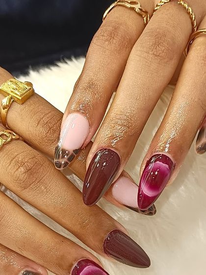 Another view of the bold and luxe manicure, showing how the different patterns and colors create a cohesive and high-fashion statement.