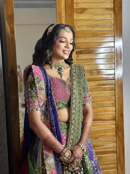 The complete look for the wedding day. The vibrant colors of her outfit are balanced with a soft, elegant makeup and hair style.