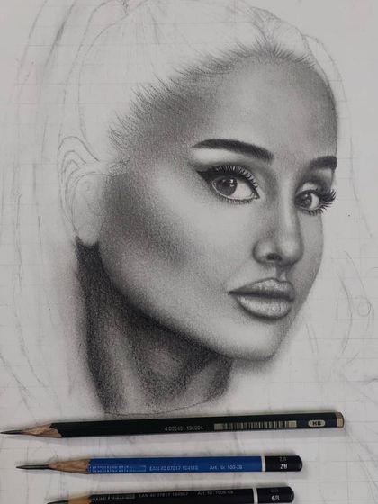 A work-in-progress of my second Ariana Grande graphite portrait. Here, the face is complete, and the hair is just an outline.
