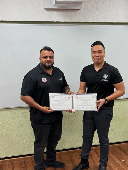 Another shot of me receiving my certification. I will keep working hard and leveling up, because that is the standard I set for myself and my fighters.