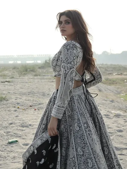 A moody, atmospheric shot of this unique lehenga, highlighting its modern yet timeless appeal.
