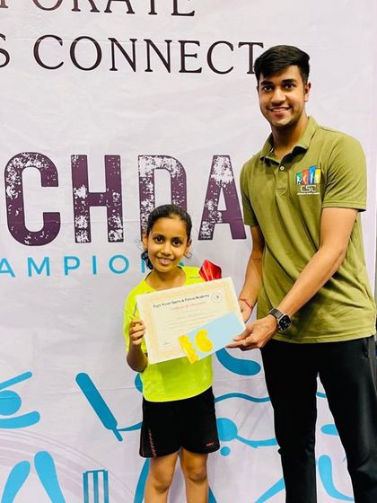 One of our coaches presenting Kashvi with her certificate and prize for winning the U-9 tournament. We ensure every player's achievement is recognized and celebrated by the team.