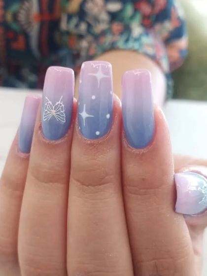 A close-up of the celestial-themed pastel ombré nails.