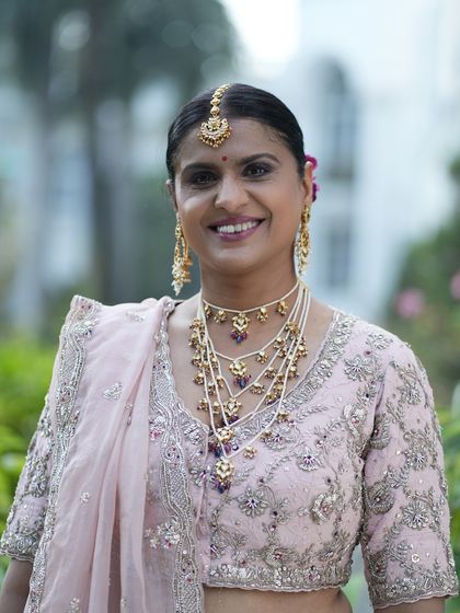 A bright and beautiful smile. The soft glam makeup enhances her features without being heavy, creating a look of timeless elegance.