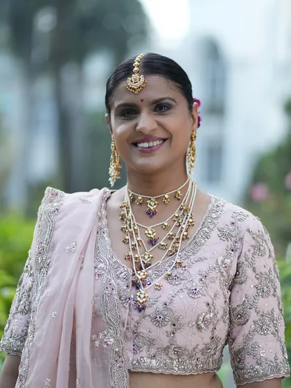 A bright and beautiful smile. The soft glam makeup enhances her features without being heavy, creating a look of timeless elegance.