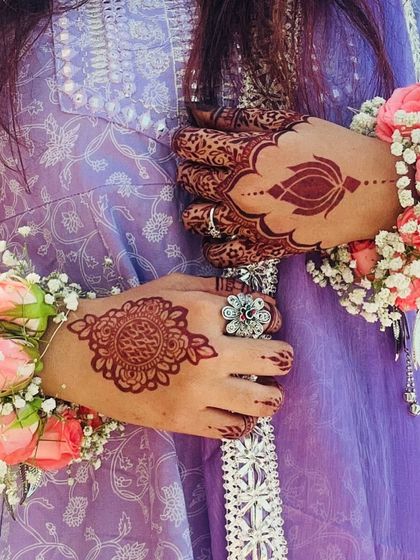 A lovely shot of the Eid henna stain, paired with floral bracelets. The mandala and lotus designs have taken on a rich, dark color.